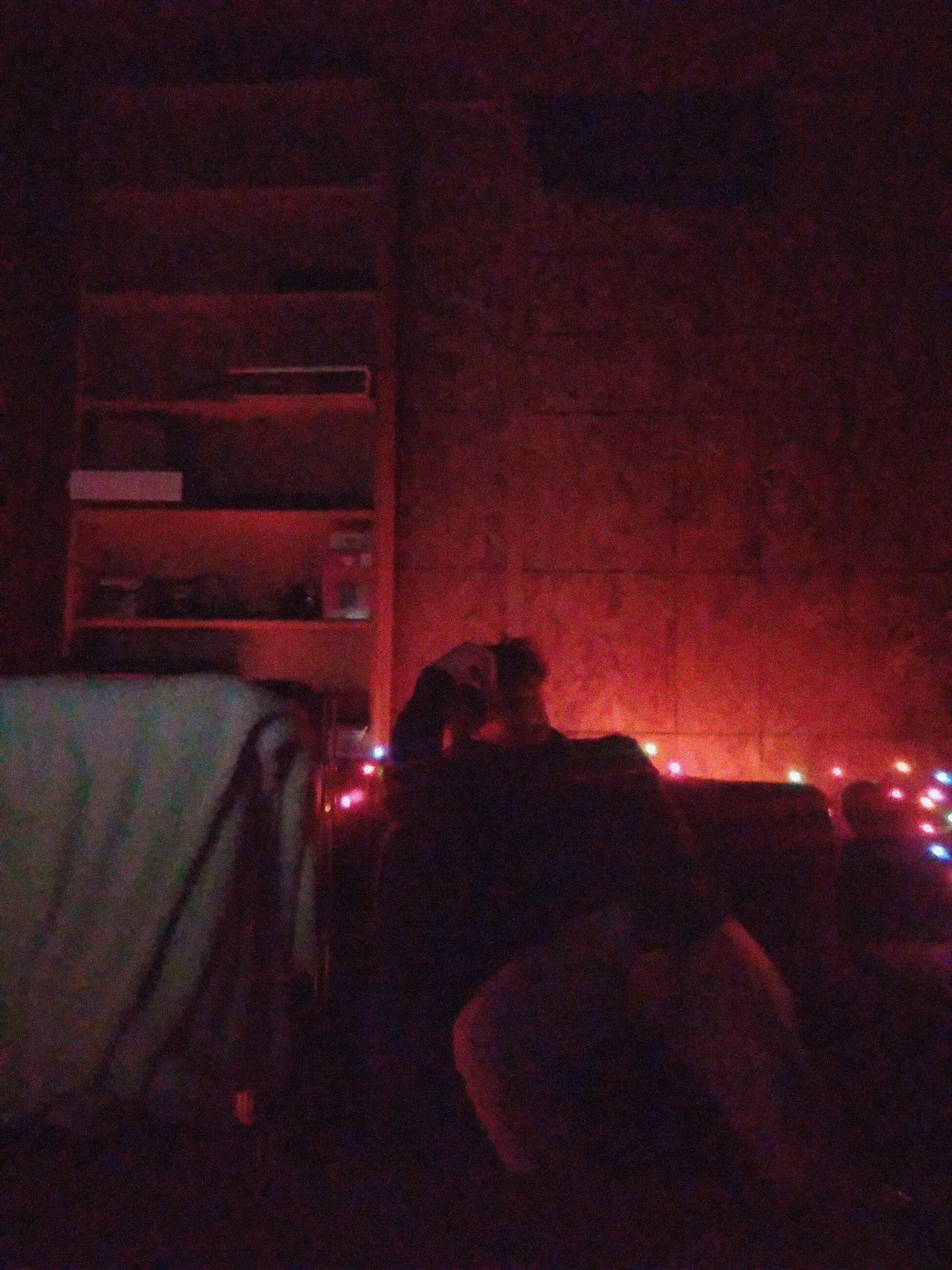 Nico on couch with soft red light behind